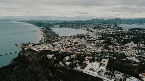 High angle view of buildings by sea against sky