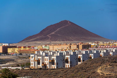 Scenic view of mountains against clear blue sky