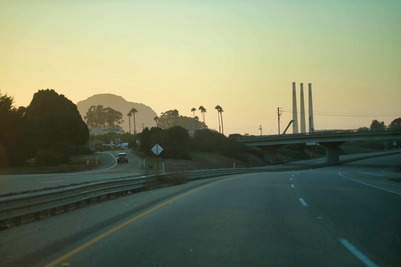 ROAD AGAINST SKY DURING SUNSET IN CITY