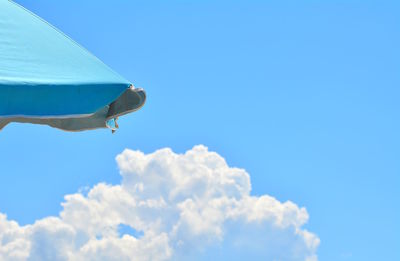 Low angle view of airplane flying against sky