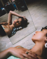 High angle view of young woman lying on floor