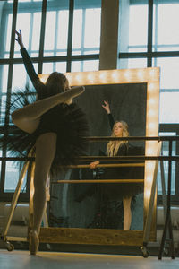 Low angle view of girl on glass window