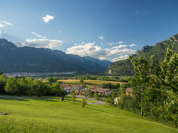 Scenic view of field and mountains against sky