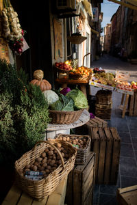 Vegetables in baskets for sale at market stall