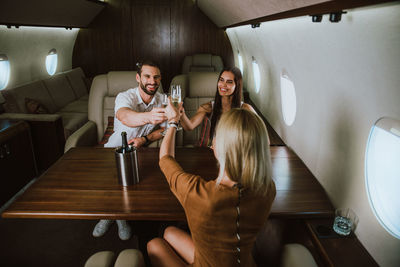 Business people having discussion while sitting in corporate jet