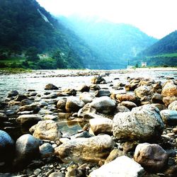 Pebbles on beach against sky