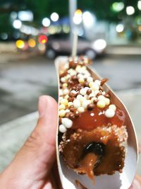 Close-up of hand holding ice cream