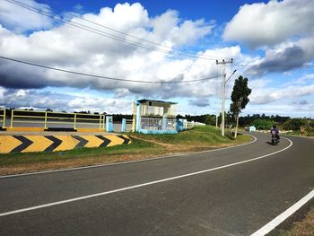 Road by city against sky
