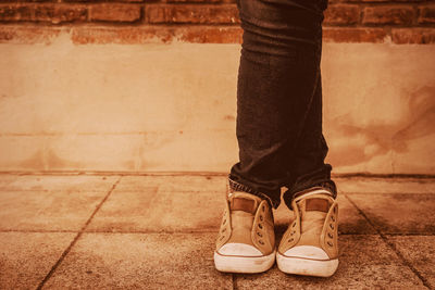 Low section of man standing on tiled floor