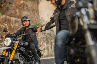 Portrait of man riding motorcycle on street