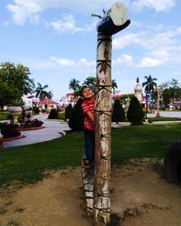 Statue in park against sky