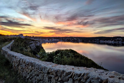 Scenic view of lake against sky during sunset