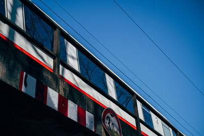 Low angle view of train against blue sky