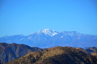 Scenic view of mountains against clear blue sky