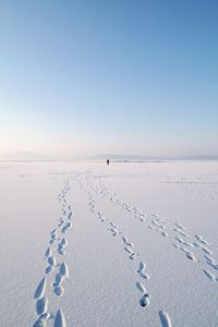 Scenic view of snow covered land against clear sky