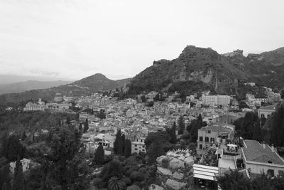 High angle view of townscape and mountains against sky