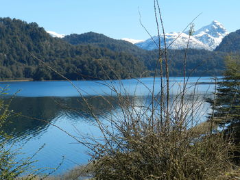 Scenic view of lake and mountains against clear sky