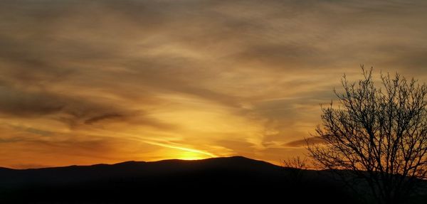 Scenic view of silhouette landscape against romantic sky at sunset