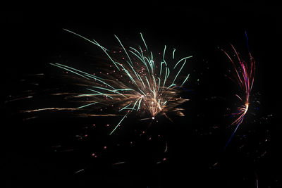 Low angle view of firework display at night