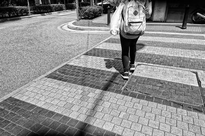 Woman walking on zebra crossing