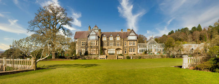 Panoramic view of trees and buildings against sky