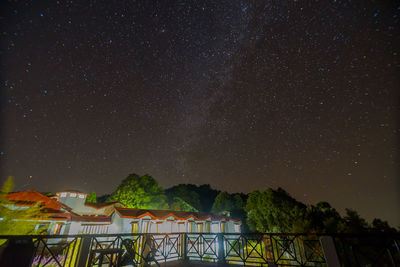 Low angle view of trees against sky at night