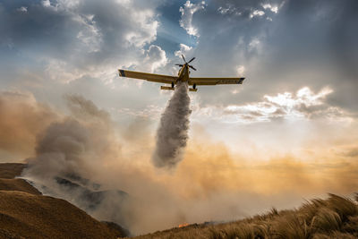 Low angle view of windmill against sky
