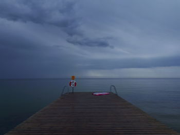 Pier over sea against sky