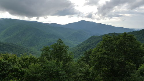 Scenic view of mountains against cloudy sky