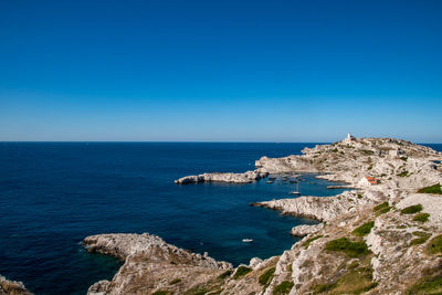 Scenic view of sea against clear blue sky