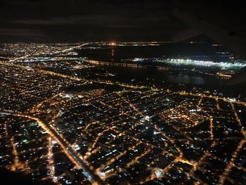 Aerial view of city lit up at night