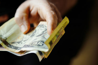 Close-up of hand holding paper currency