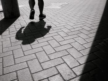 Low section of man walking on street