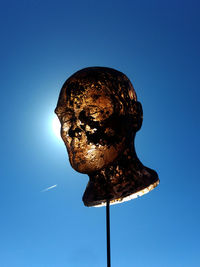 Low angle view of statue against blue sky