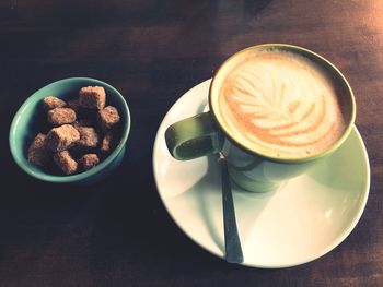 Close-up of cappuccino served on table