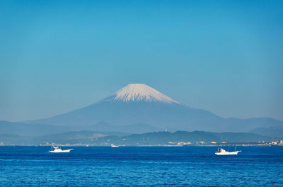 Scenic view of sea against clear blue sky