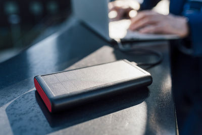 Solar battery charger connected to laptop being used by businessman