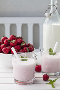 High angle view of fruits and smoothie in glass on table