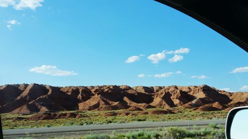 Scenic view of landscape against blue sky