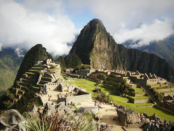 Old ruins on mountain against cloudy sky