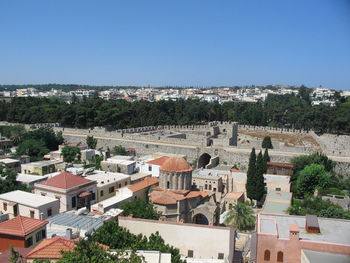 High angle view of houses in town against clear sky