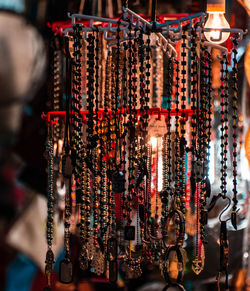 Close-up of necklaces hanging at market stall