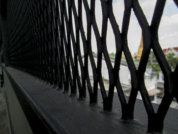 Close-up of railing by footpath