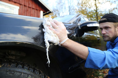 Man cleaning car outdoors