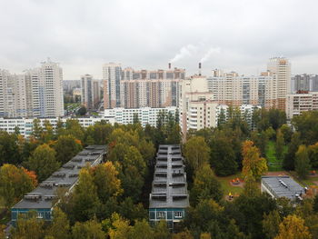 High angle view of buildings and trees against sky