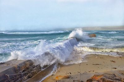 Waves breaking against sea