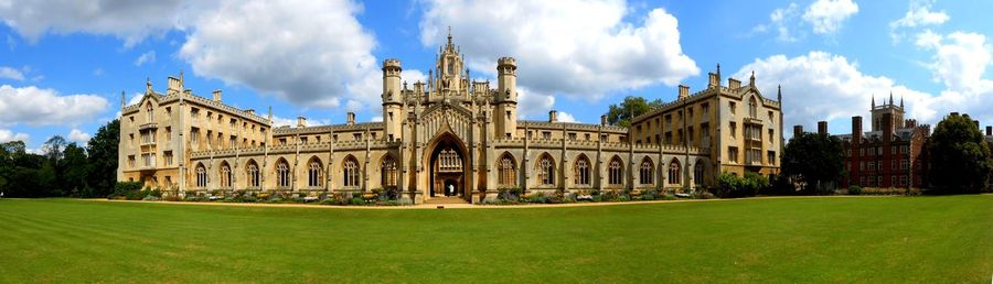 Panoramic shot of the front of st john's college cambridge uk with clouds and blue sky