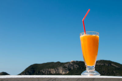 Close-up of drink against blue sky