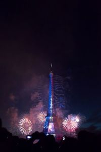 Low angle view of firework display at night