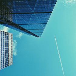 Low angle view of modern building against blue sky